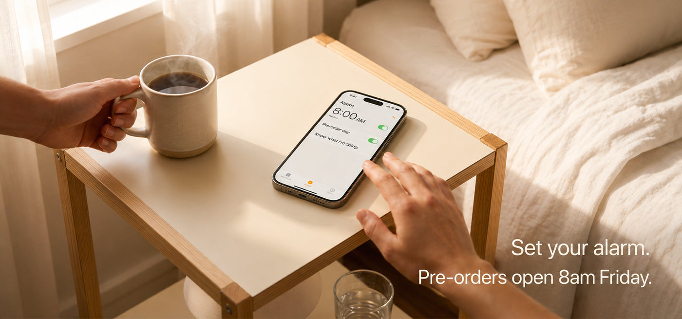 iPhone alarm set to 8am for iPhone 18 pre-order day on a bedside table — pre-orders open 8am Friday after Apple September 2026 announcement